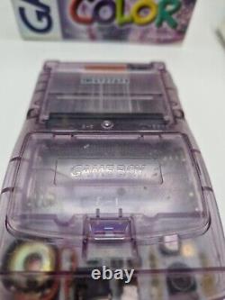 Game Boy Color violette atomique en boîte avec tous les manuels et la console