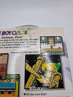 Game Boy Color violette atomique en boîte avec tous les manuels et la console