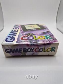 Game Boy Color violette atomique en boîte avec tous les manuels et la console